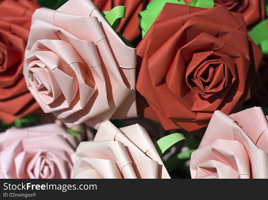 A macro picture of pink and red paper roses