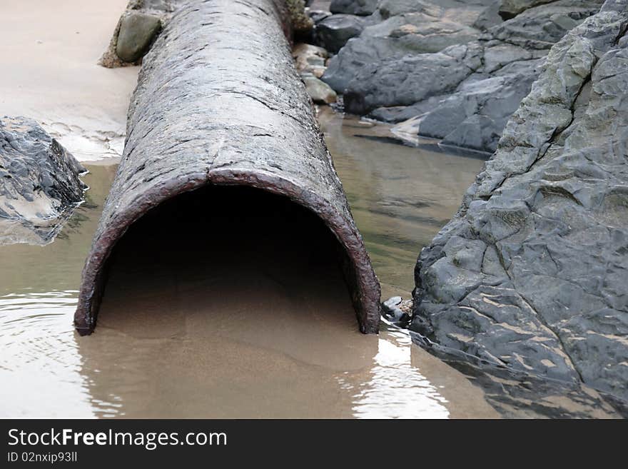 Rusty overflow seashore pipe