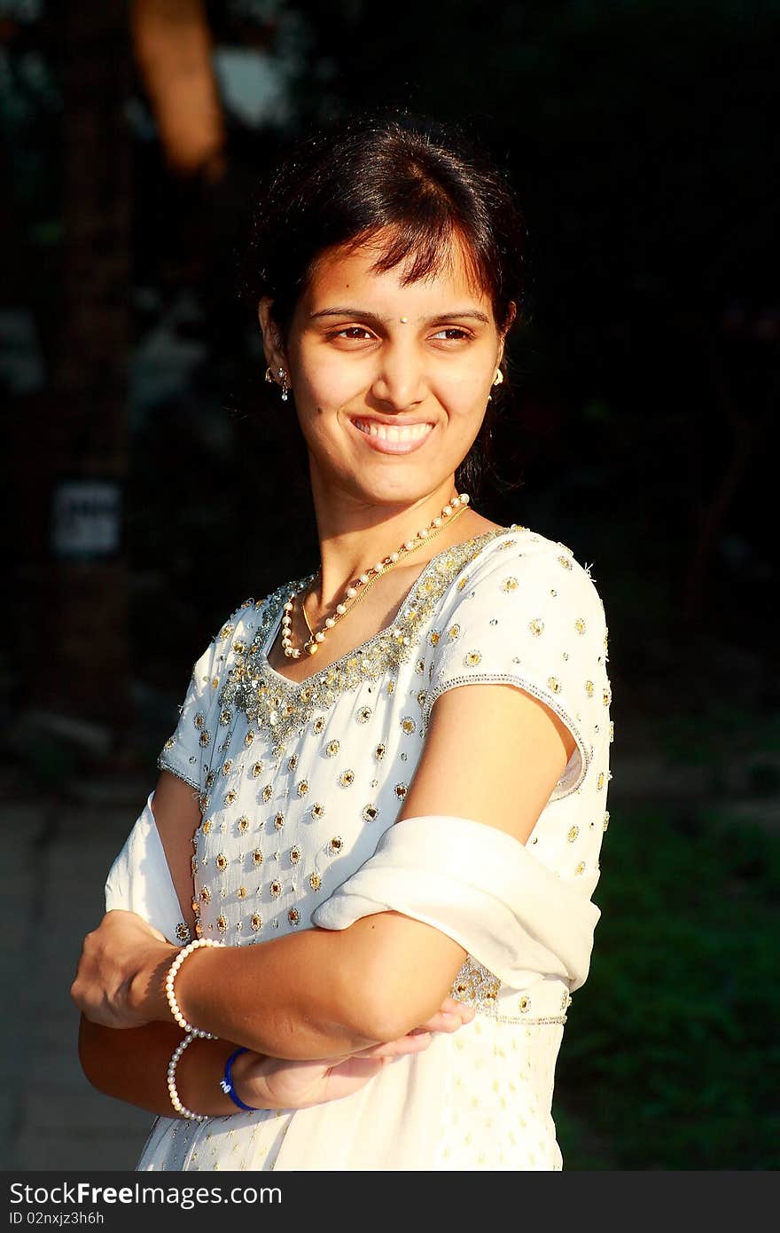 A bright Indian princess in a relaxed and casual mood smiling happily.