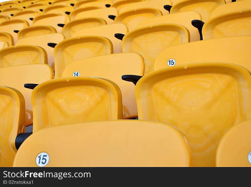 Folding yellow seat row in arena. Folding yellow seat row in arena