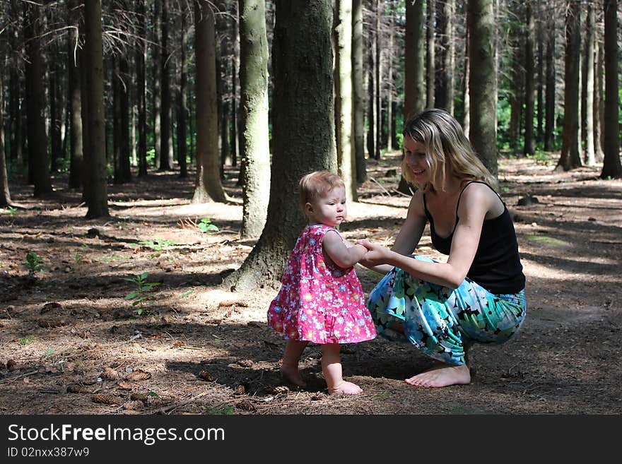 The mum with the daughter near a tree. The mum with the daughter near a tree