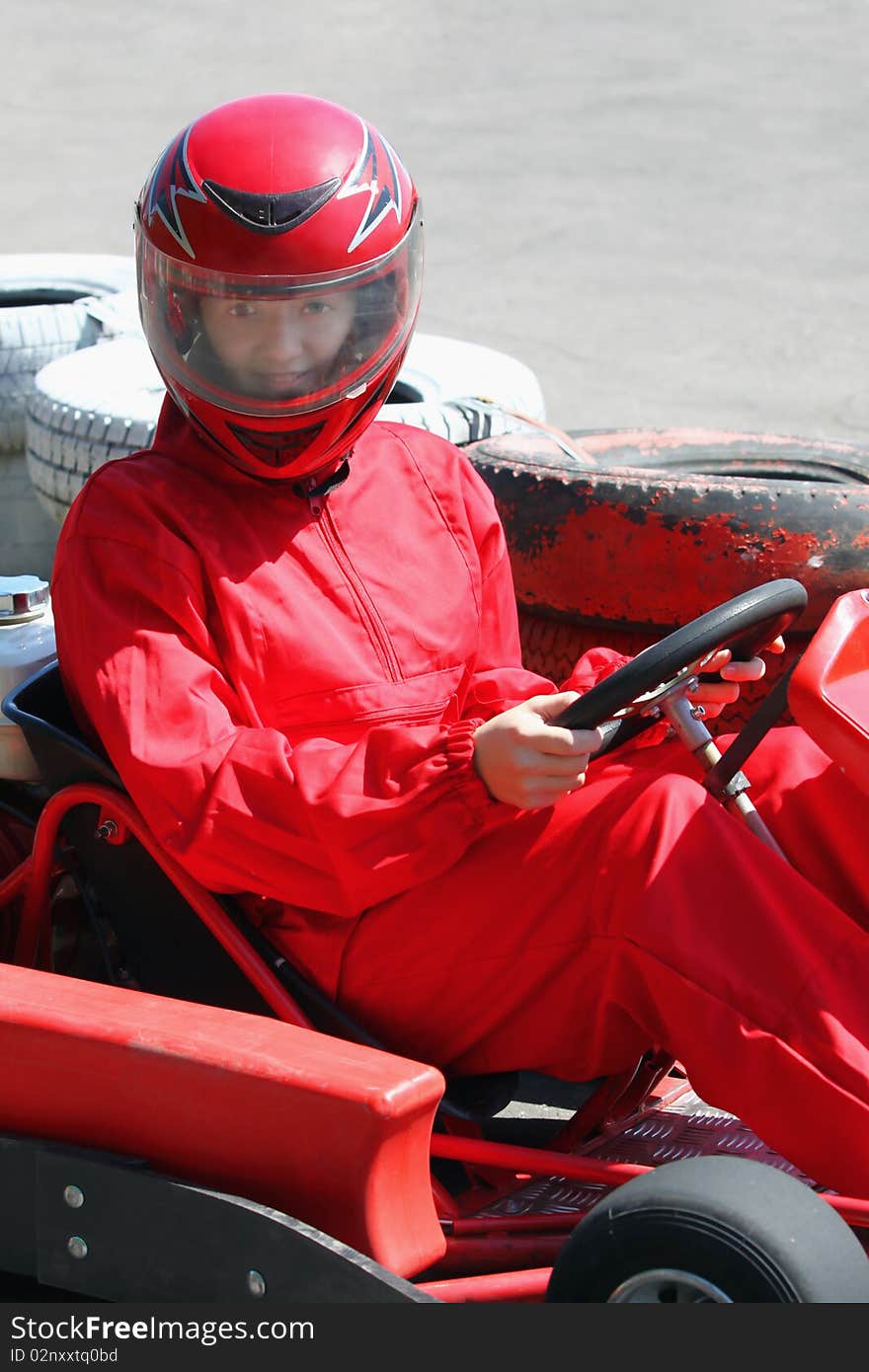 A smiling young  racer in helmet. Go-cart race