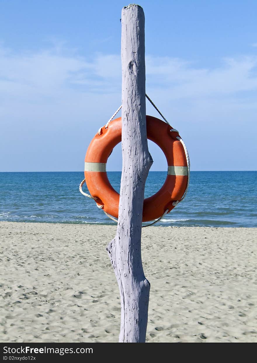 Safe Pole With Lifebelt On A Solitary Beach