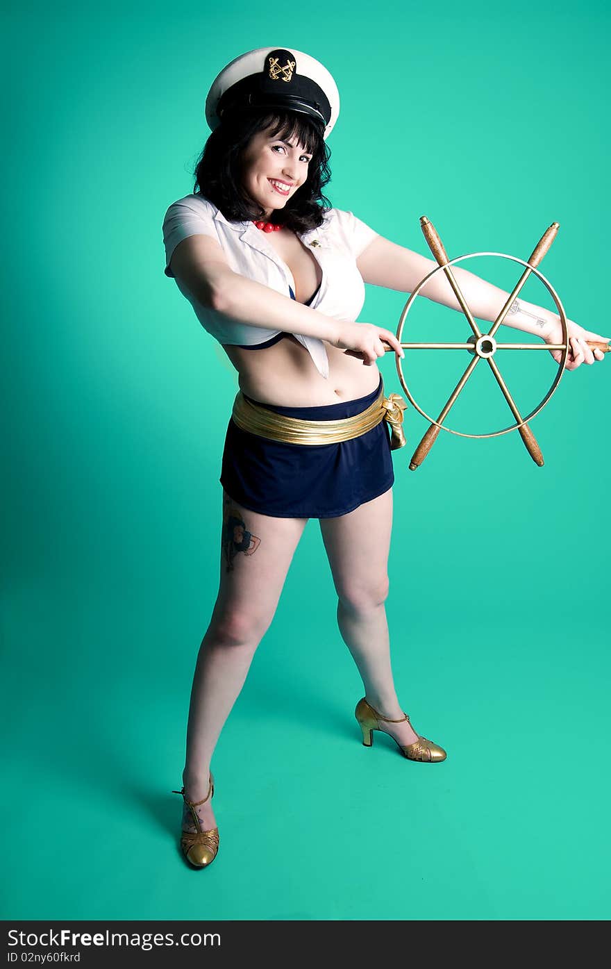 Nautical pinup girl with boat steering wheel