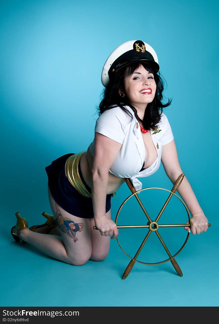 Nautical pinup girl with boat steering wheel