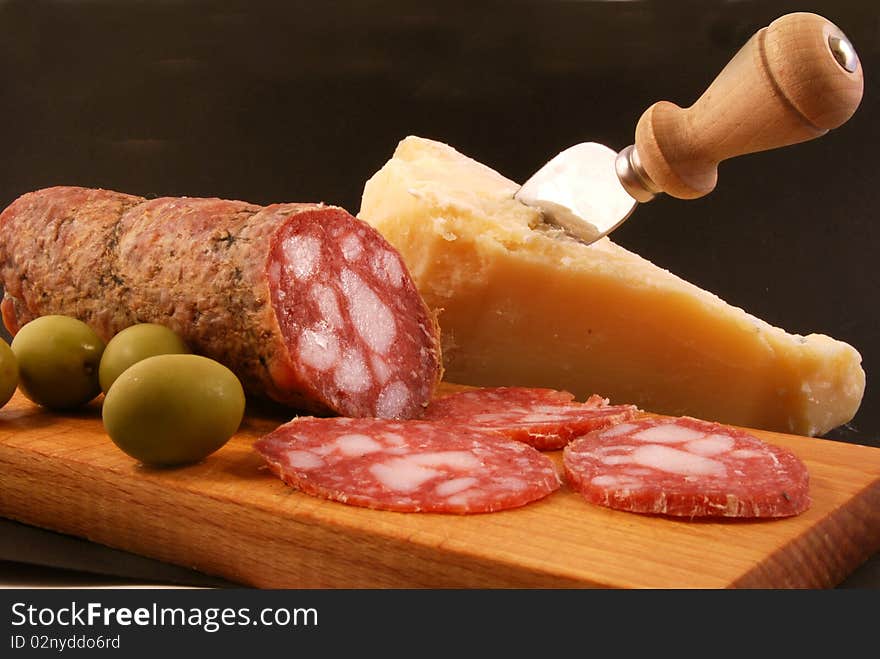 Salami with green olives and parmesan cheese