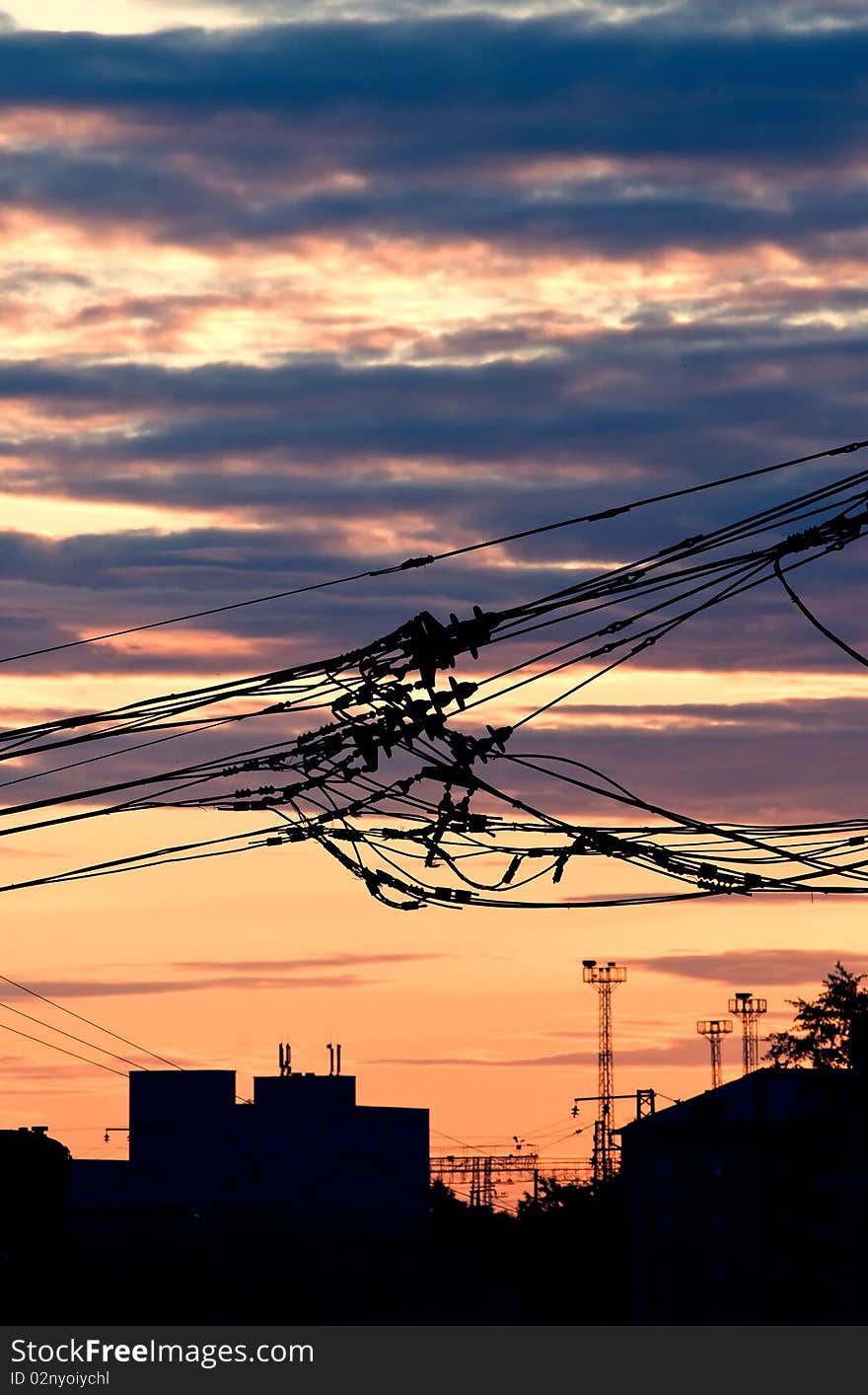 Bunch of electric wires over the sunset in the city