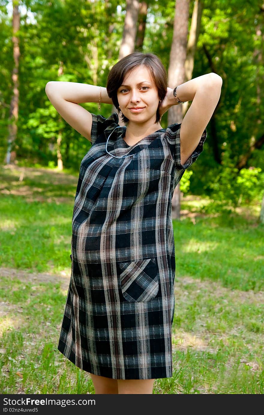 Beautiful pregnant woman in the park