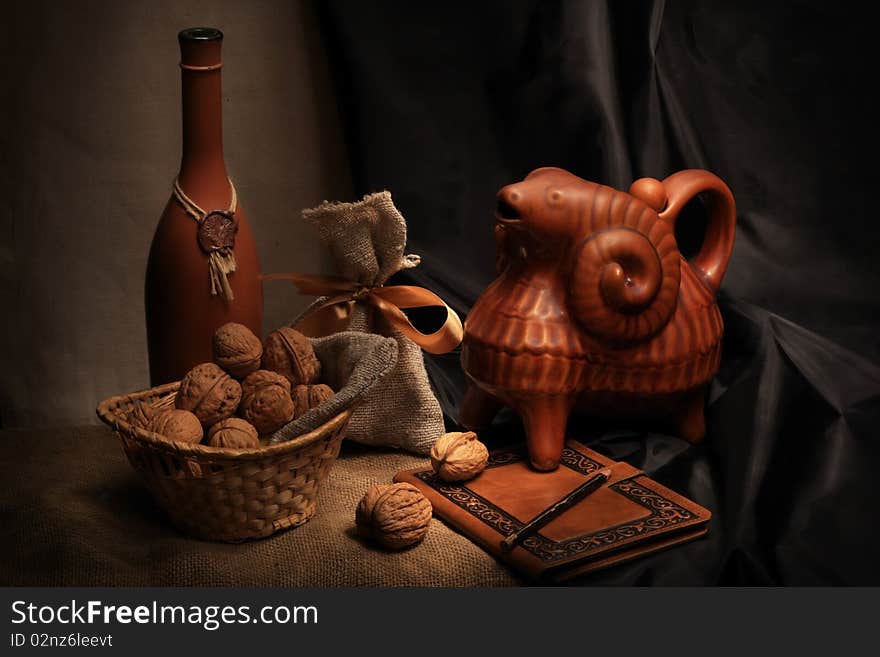 Vintage still life with wine, walnuts and ceramic ram. Vintage still life with wine, walnuts and ceramic ram