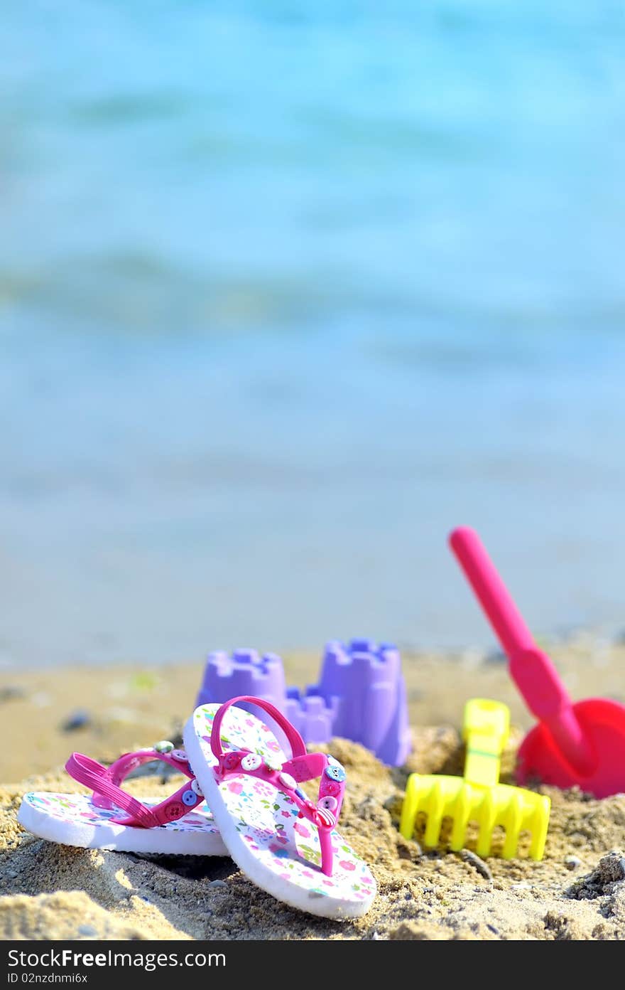 Children's beach accessories with sea background