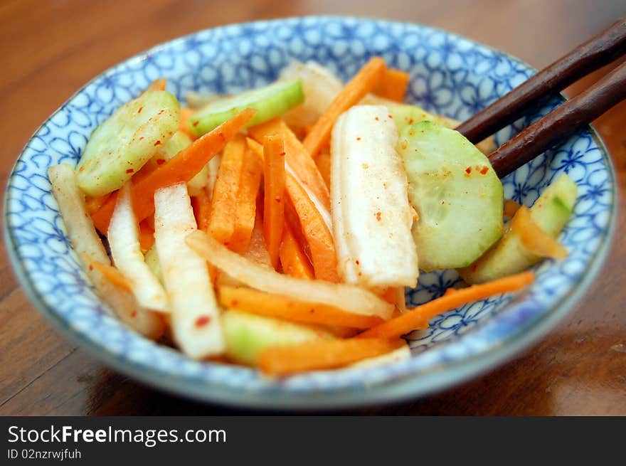 A small kimchi salad with chopsticks