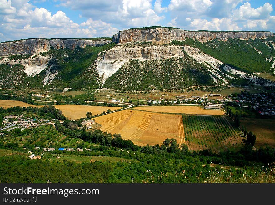 Rocks And Green Field