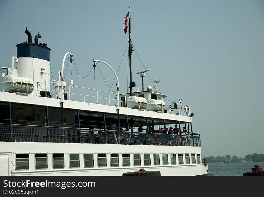 Ferry leaving dock carrying passengers