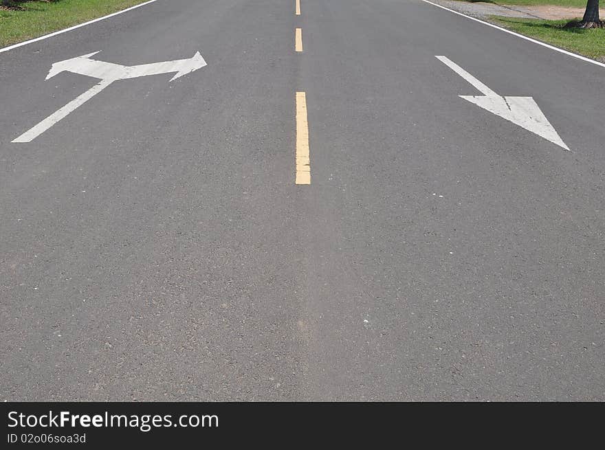 Arrow traffic symbol on the asphalt road