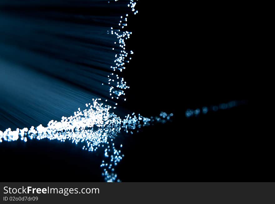 Close up on the ends of fibre optic light strands reflecting on black. Close up on the ends of fibre optic light strands reflecting on black.