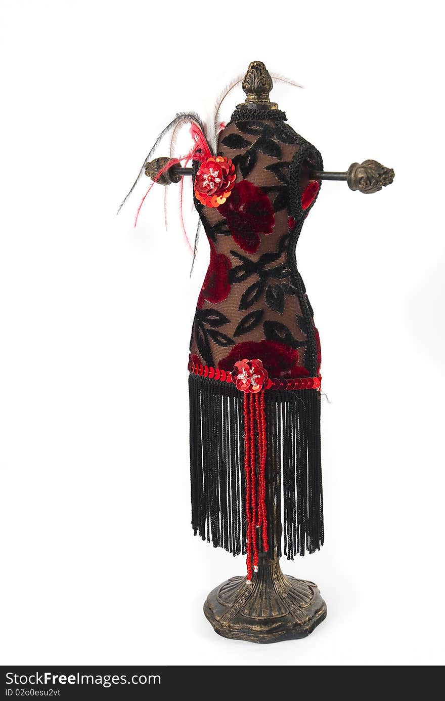 Black and red jewelry holder with feathers on a white background