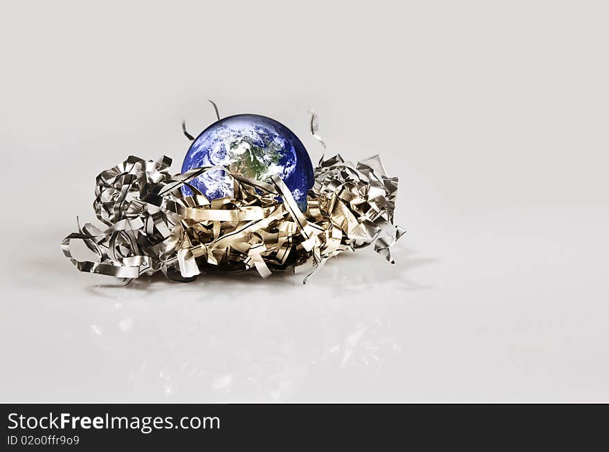 Planet Earth in the embrace of a metal garbage