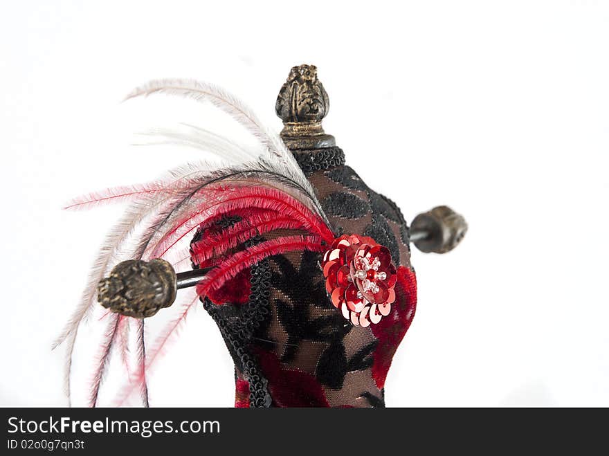 Black and red jewelry holder with feathers on a white background