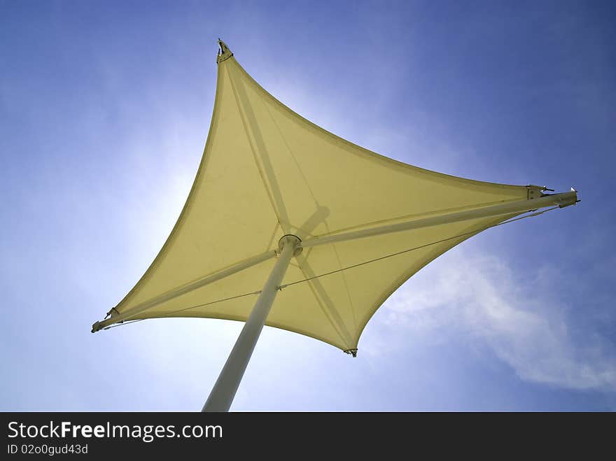 White canvas umbrella and sky