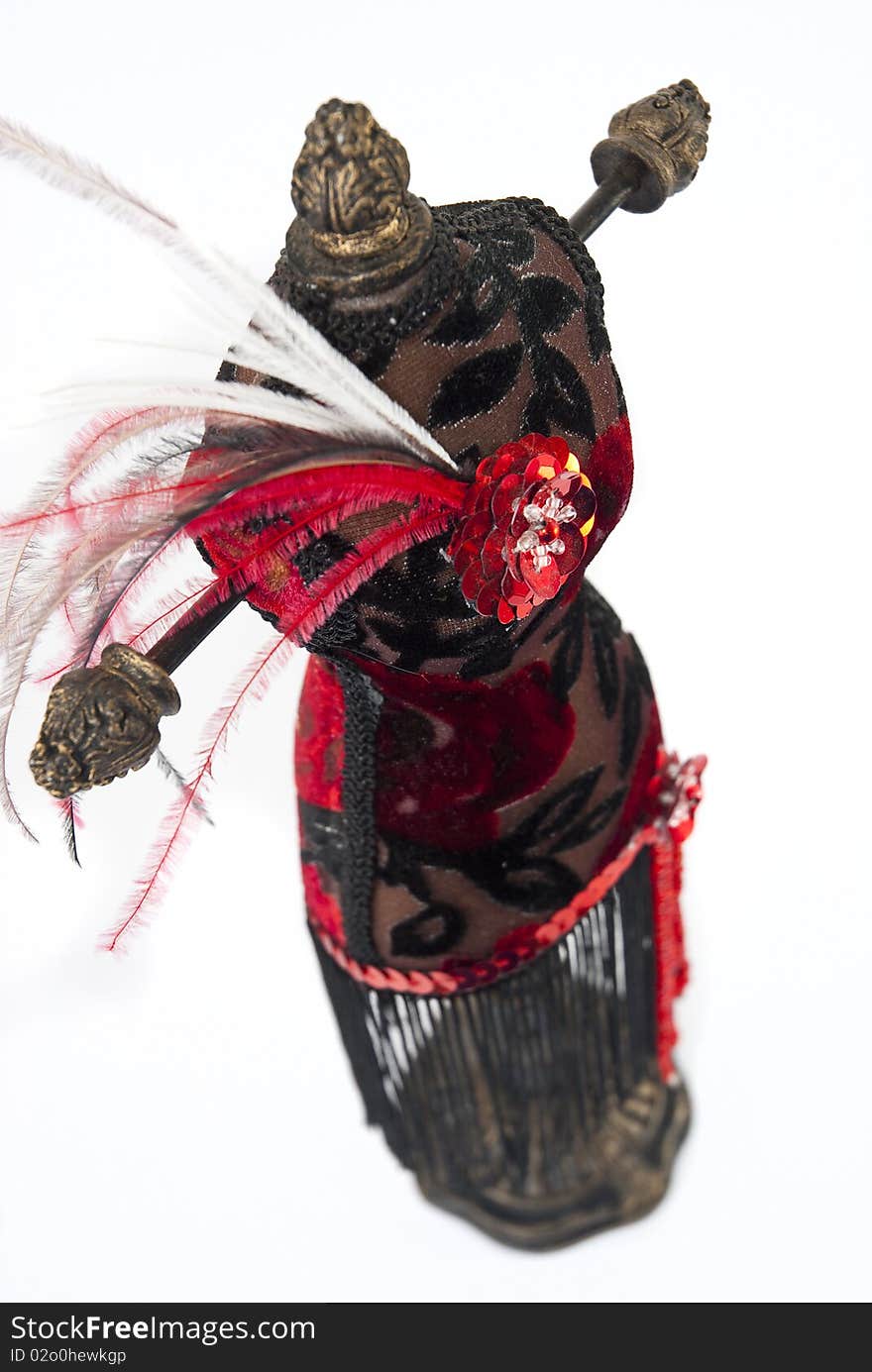 Black and red jewelry holder with feathers on a white background