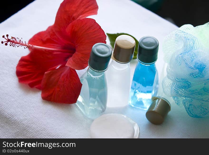 Bottles and soap on the white towel close up. Bottles and soap on the white towel close up