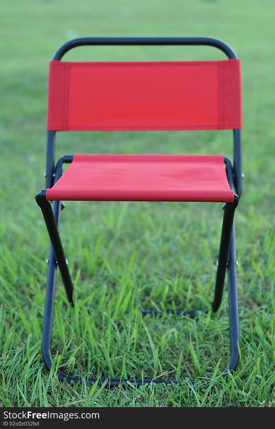 Folds chair in the lawn background. Folds chair in the lawn background