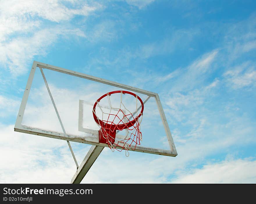 Outdoor basketball hoop on a blue sky background. Outdoor basketball hoop on a blue sky background