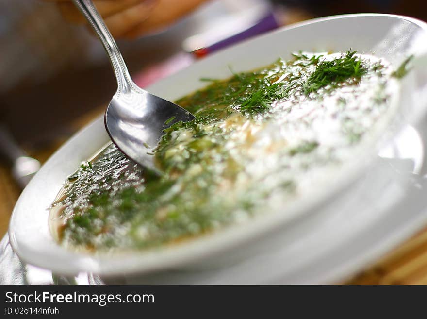 Soup with aneth, sour creme and vegetables.