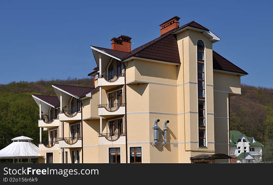 Beautiful building of medical dwelling corps on a background mountains and dark blue sky