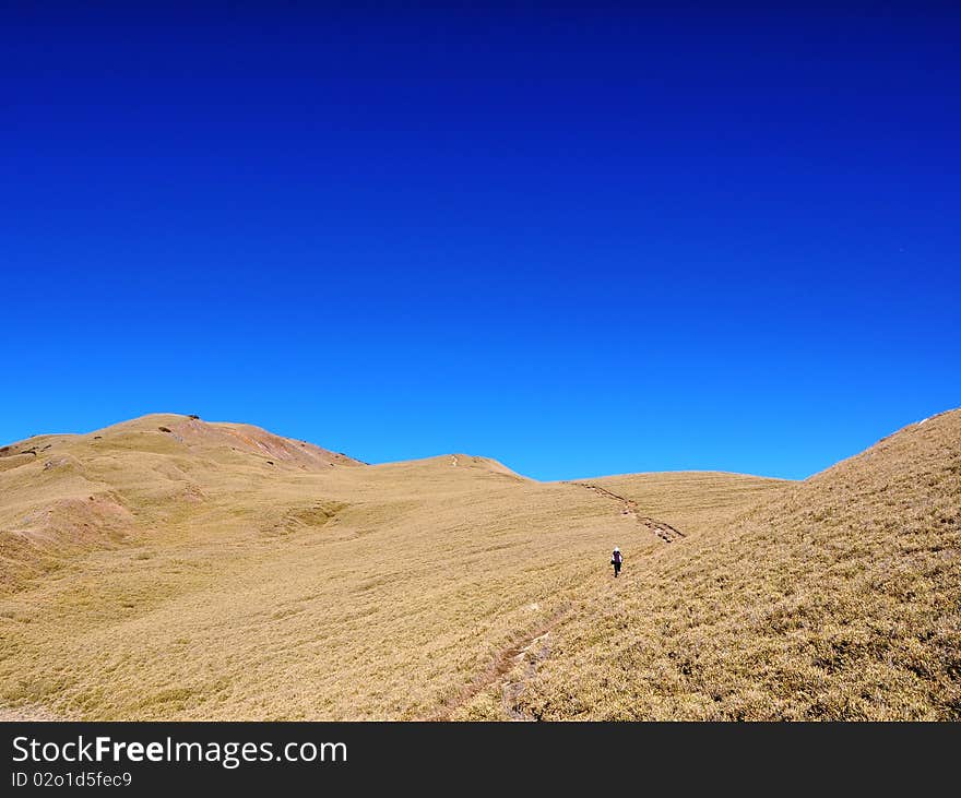 Blue sky on the highland with a hiker. Blue sky on the highland with a hiker