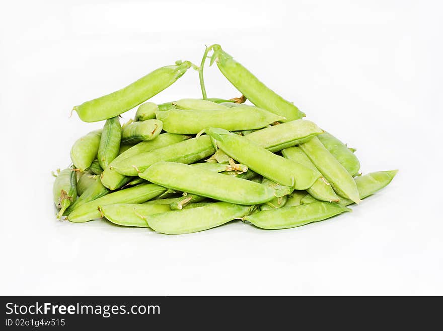 Pods of green pea are isolated on white