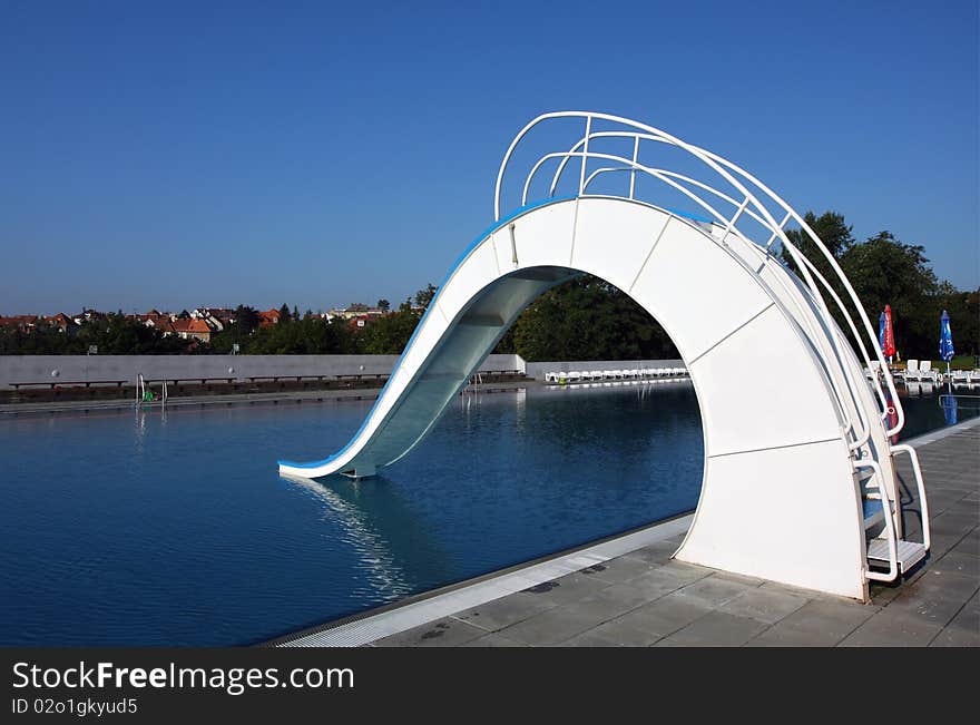 Dispeopled bath pool with white slide