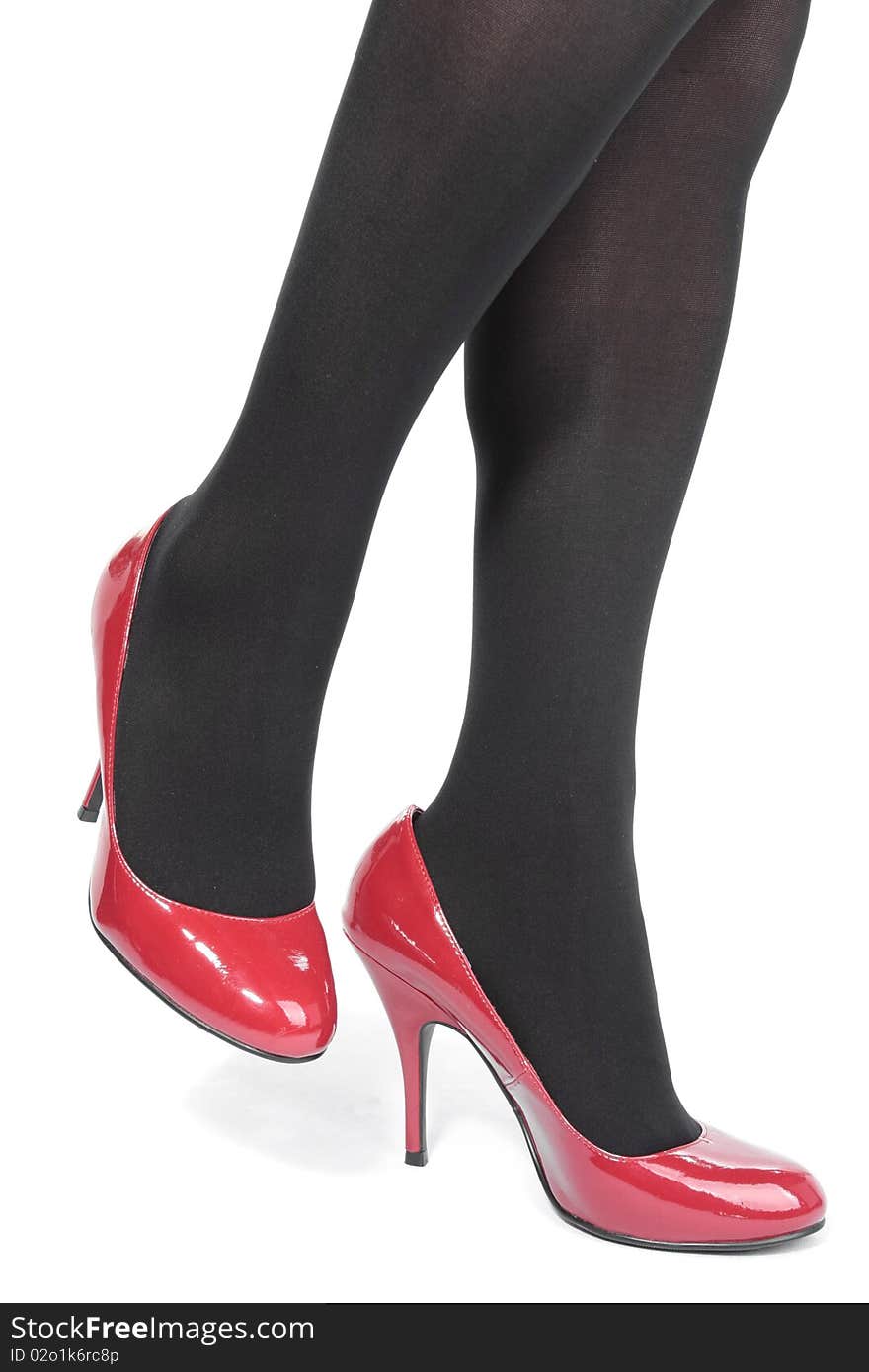 Beautiful woman legs tights with red heels over white. Beautiful woman legs tights with red heels over white