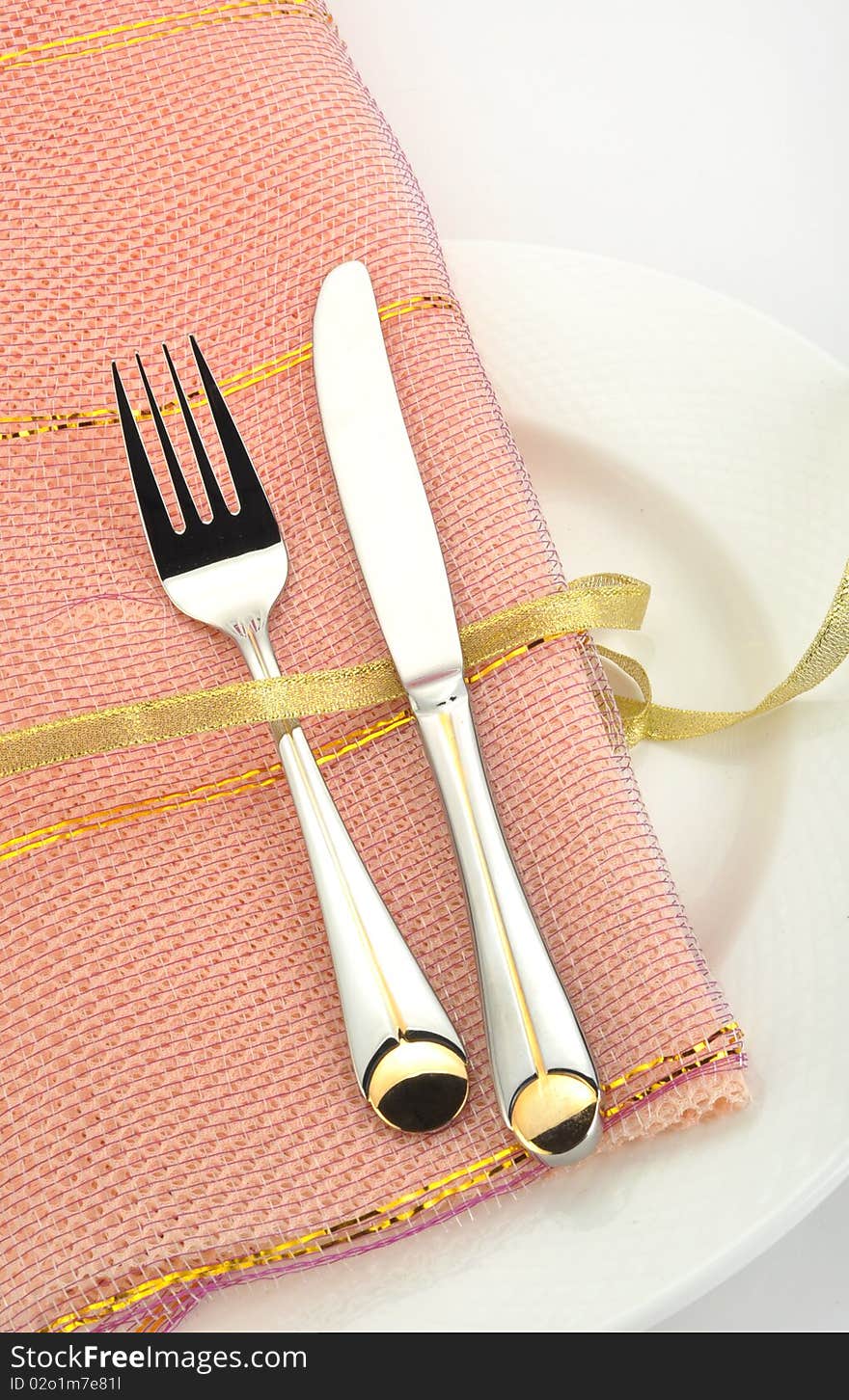 Close-up fork and knife on a placemat. Close-up fork and knife on a placemat