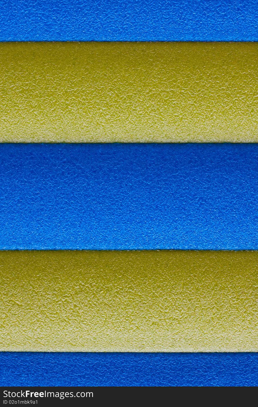 Foam abstract texture or background with blue and yellow from water toy