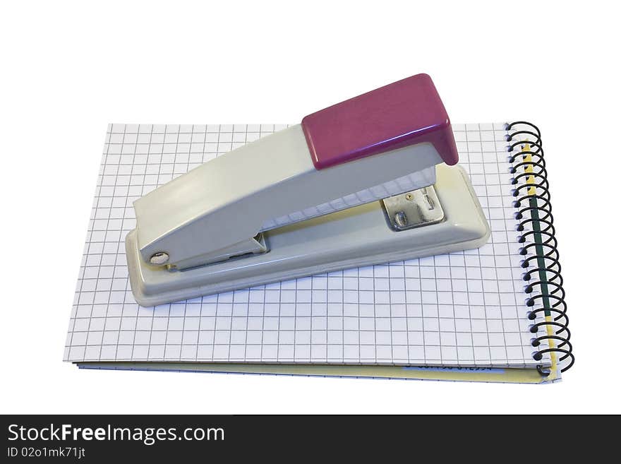 Stapler and notebook isolated on the white