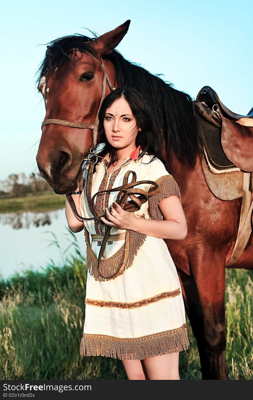 Beautiful young woman posing with a brown horse. Beautiful young woman posing with a brown horse.