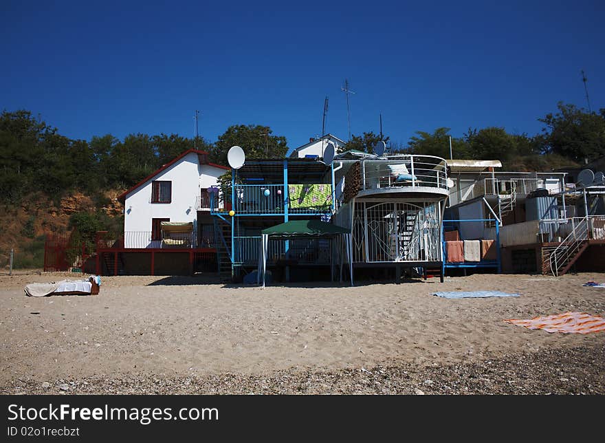 Summer small houses on sandy sea coast