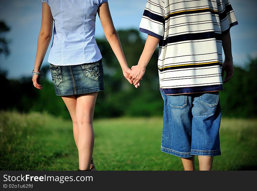 Couple walking outdoor and holding hands. Couple walking outdoor and holding hands