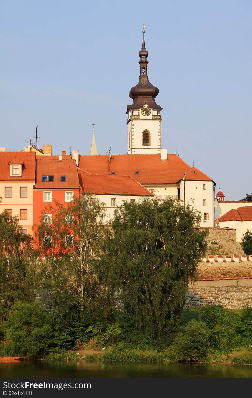 The colorful medieval town Pisek in Czech Republic with gothic deanery Church above the river Otava