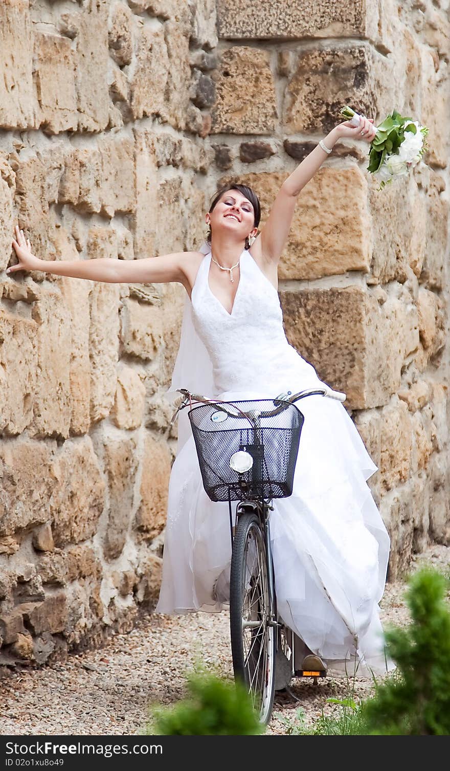 Happy bride riding on a bike