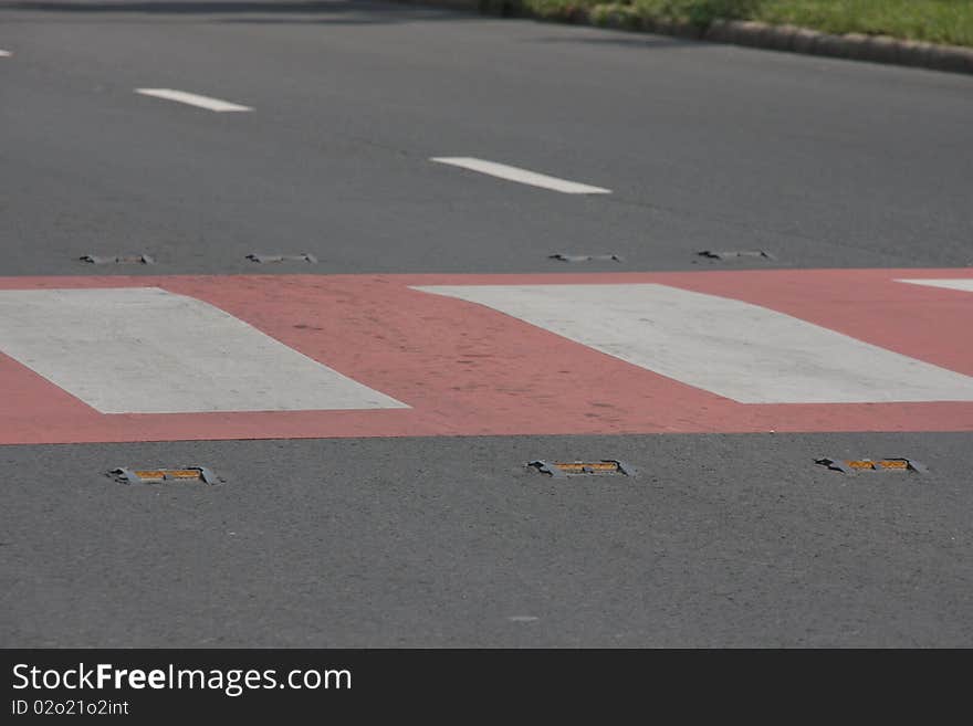 Crosswalk with red attracting coloration, a light-reflecting prism for the safe traffic. Crosswalk with red attracting coloration, a light-reflecting prism for the safe traffic.