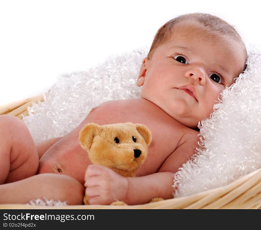 Close-up of a newborn in a fluff-lined blanket clutching a small brown teddy bear.  Isolated on white. Close-up of a newborn in a fluff-lined blanket clutching a small brown teddy bear.  Isolated on white.