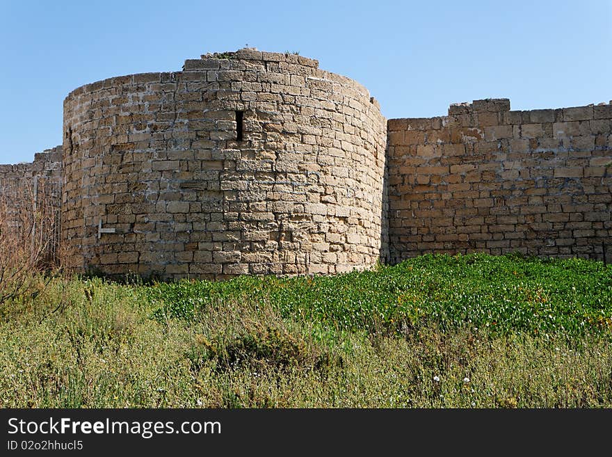 Round Tower And Wall Of Medieval Castle Among Gras