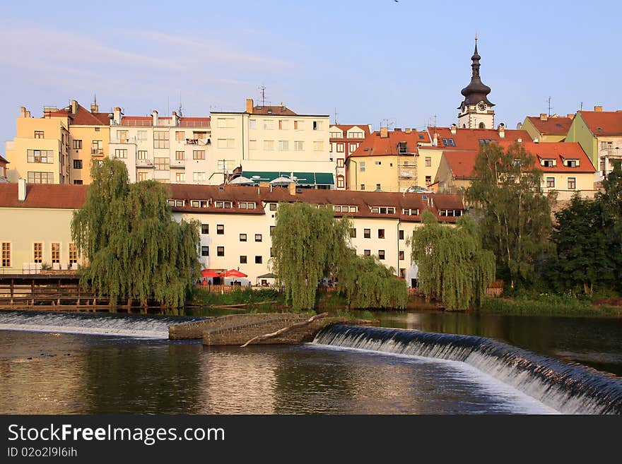 The colorful medieval town Pisek in Czech Republic with gothic deanery Church above the river Otava