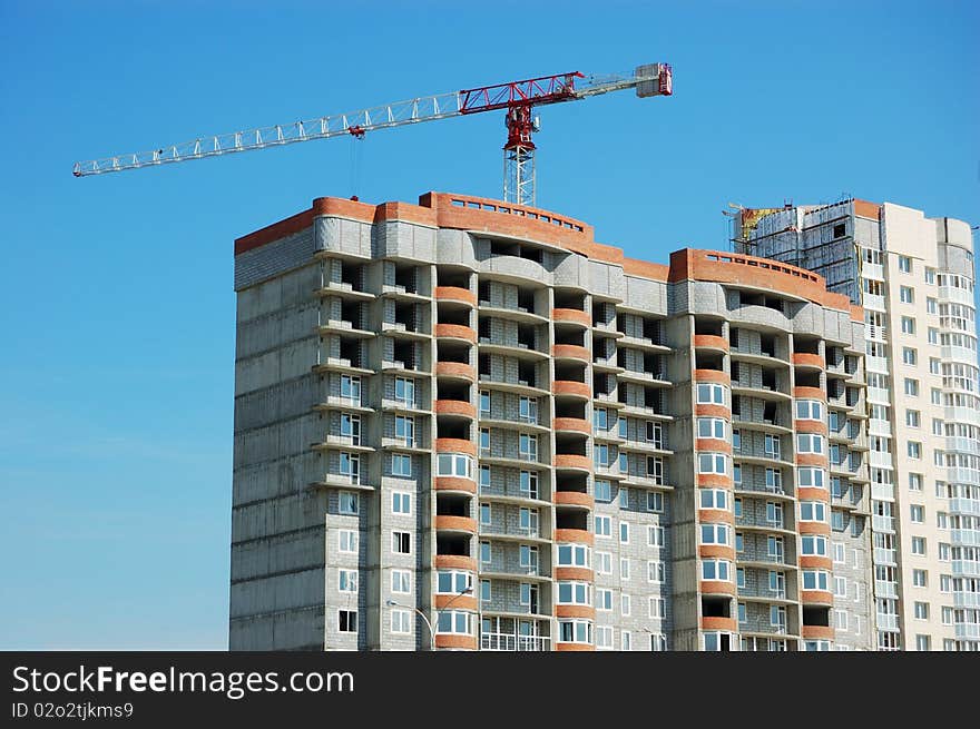 Building under construction with lifting crane