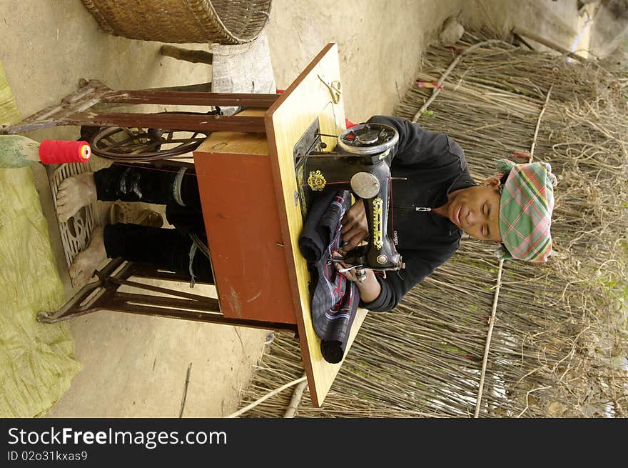 Black Hmong woman sewing machine