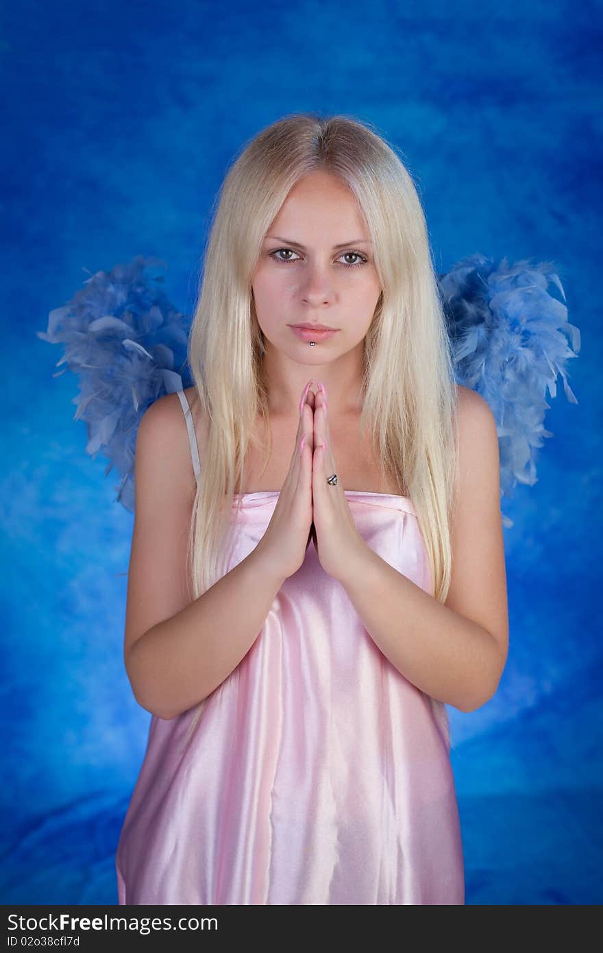 Beautiful girl posing on a blue background. Beautiful girl posing on a blue background