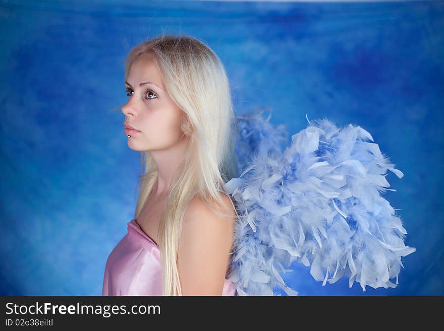 Beautiful girl posing on a blue background. Beautiful girl posing on a blue background