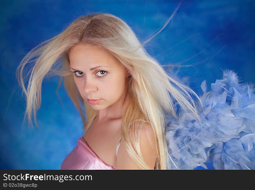 Beautiful girl posing on a blue background. Beautiful girl posing on a blue background